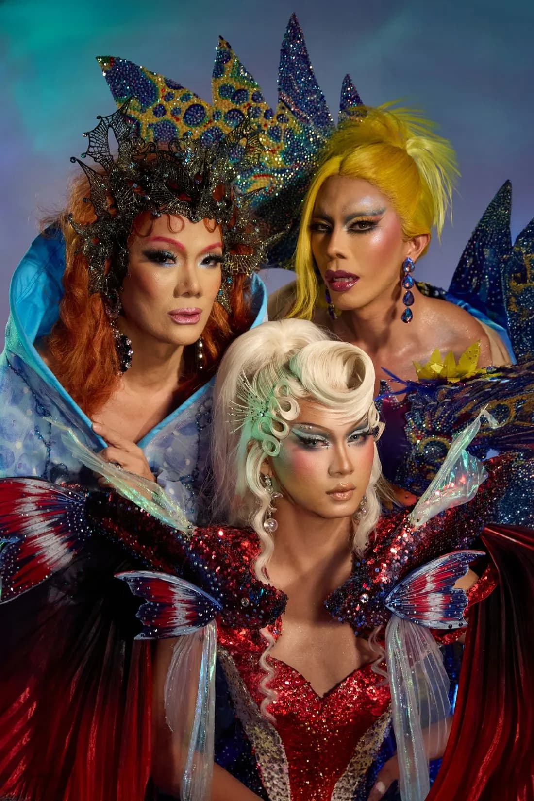 Three Heals queens together in crowns, fins and sequins